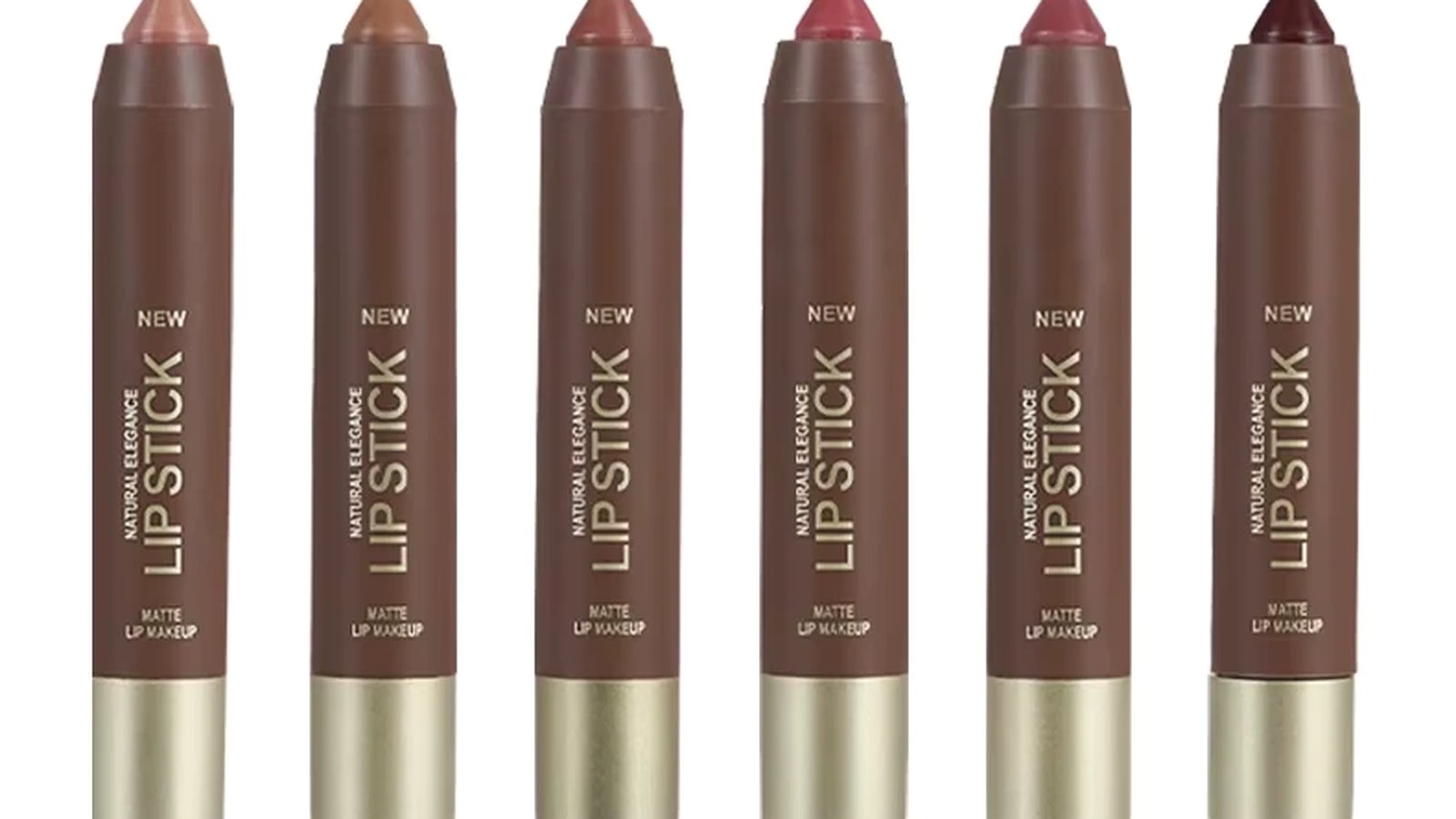 Nude and brown matte lip crayons fanned out on a warm neutral surface beside a sharpened tip and a nude swatch